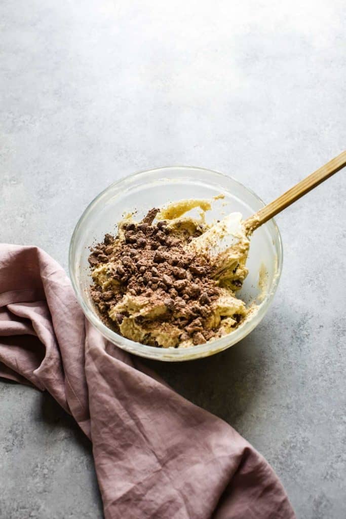 cookie mix with chocolate chips and a spatula in a bowl