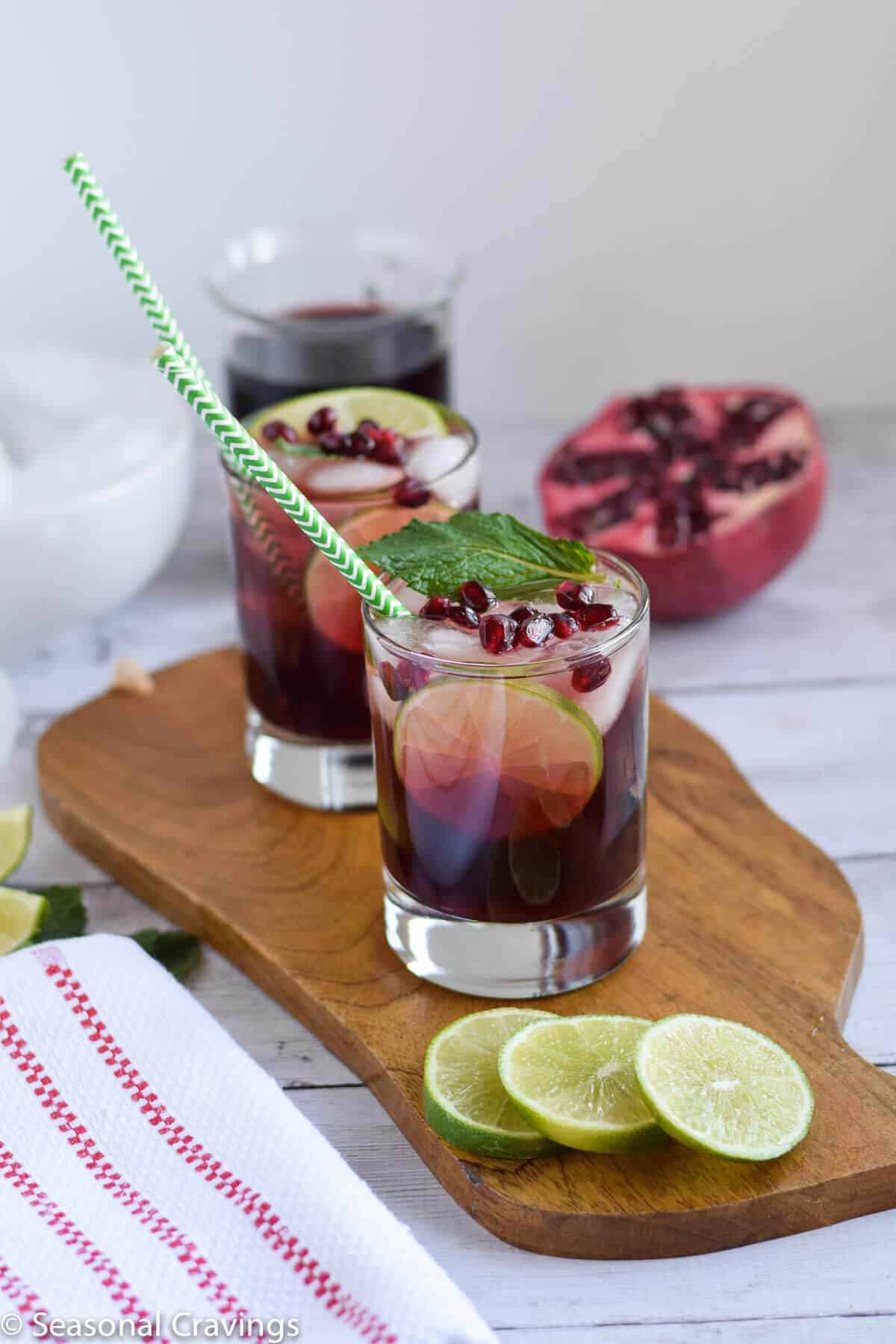 Easy Pomegranate Mojito in two glasses with pomegranate on the side