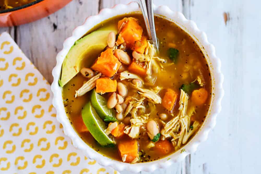 White Chicken Chili with avocado and lime for garnish