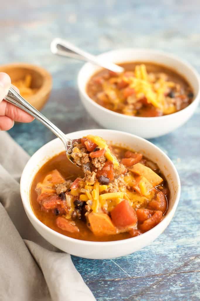 turkey chili recipe in white bowls with spoons