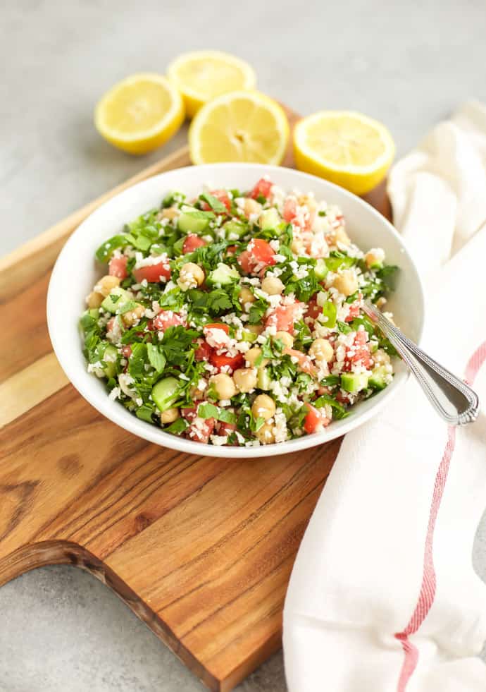 Cauliflower Tabbouleh on a white plate on a cutting board