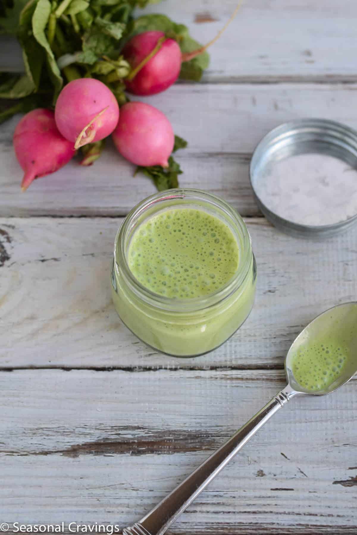 Green Cauliflower Rice Salad dressing in a small jar