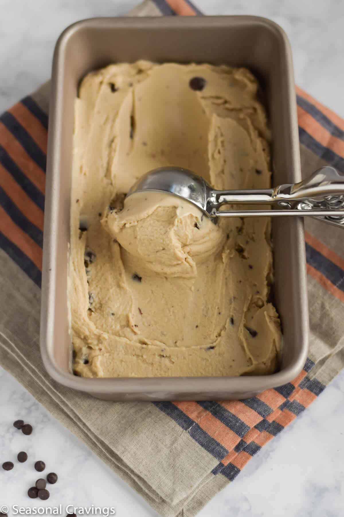 Coconut Espresso Ice Cream in a loaf pan with ice cream scoop