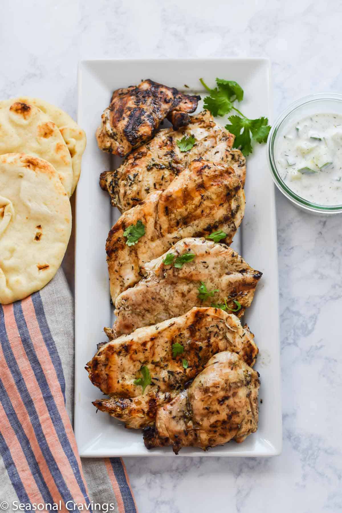  Chicken Souvlaki on a white plate with bread