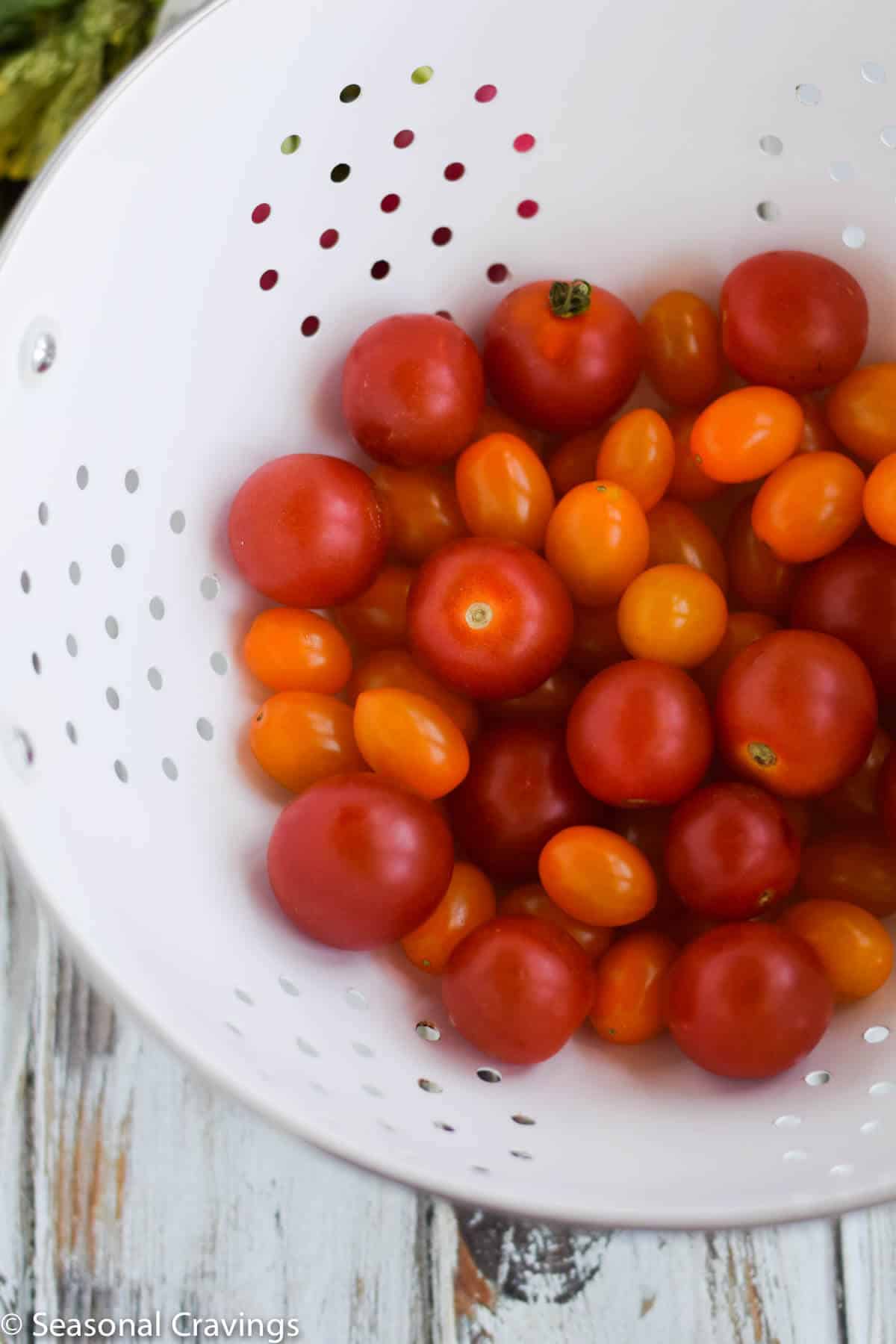 Late Summer Quinoa Grain Bowl tomatoes in a colander