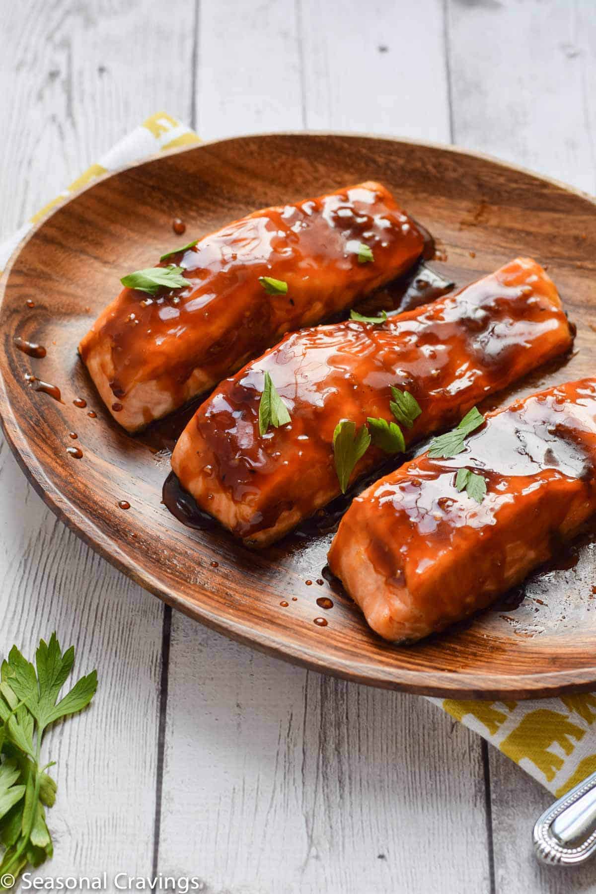 salmon teriyaki with sweet sticky glaze on a wooden plate