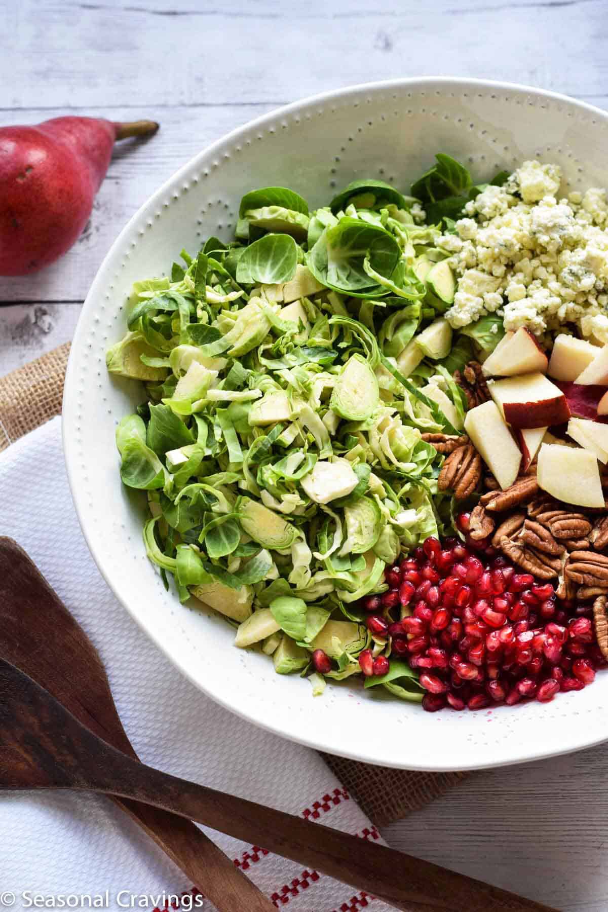 Brussel Sprout Salad with Pear and Pomegranate - delicious fall salad with brussel sprouts, pears, pecans, blue cheese and pomegranate arils {gluten free}