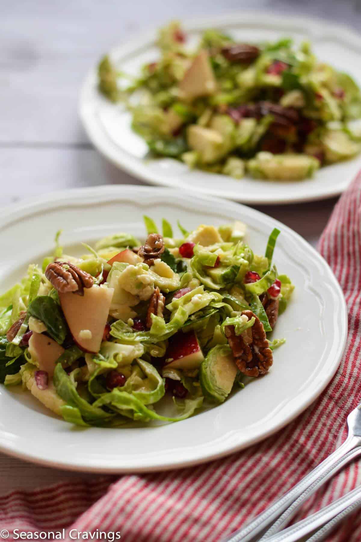 brussels sprout salad on two white plates