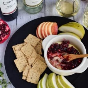 A plate with cranberry dip and crackers for pairing with wine.