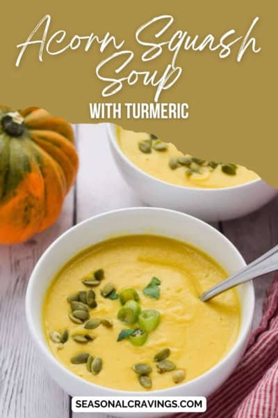 Two bowls of acorn squash soup with turmeric, garnished with pumpkin seeds and herbs. An acorn squash is placed beside the bowls. Text on the image reads "Delicious Acorn Squash Soup with Turmeric.