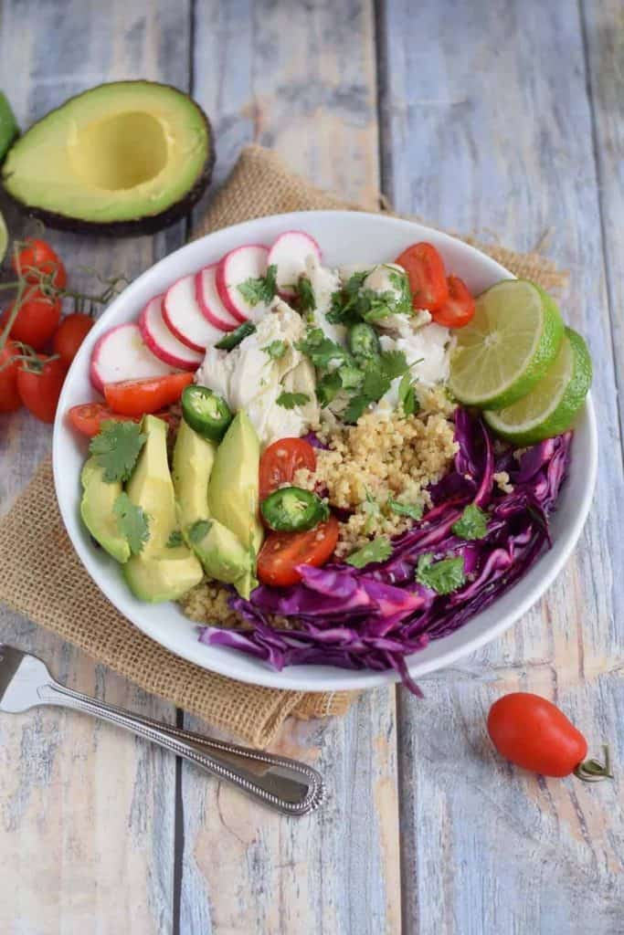 Fish Taco Grain Bowl in white bowl with avocado