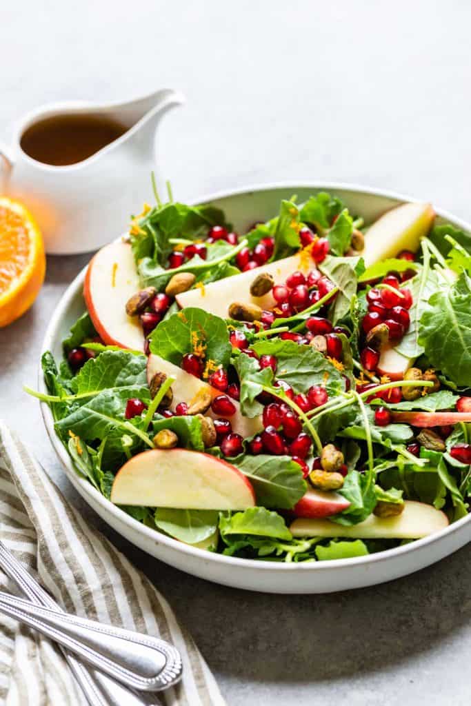 kale salad with orange and dressing on the side