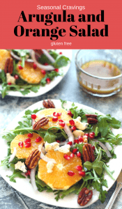 Arugula and orange salad with pomegranate and seeds.