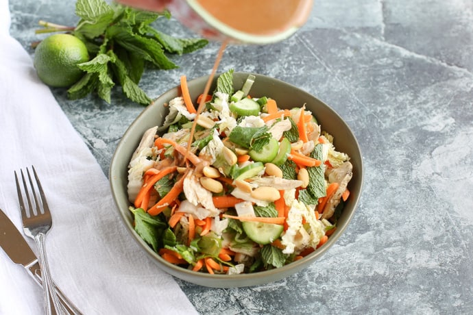  Thai Chicken Salad with dressing pouring on