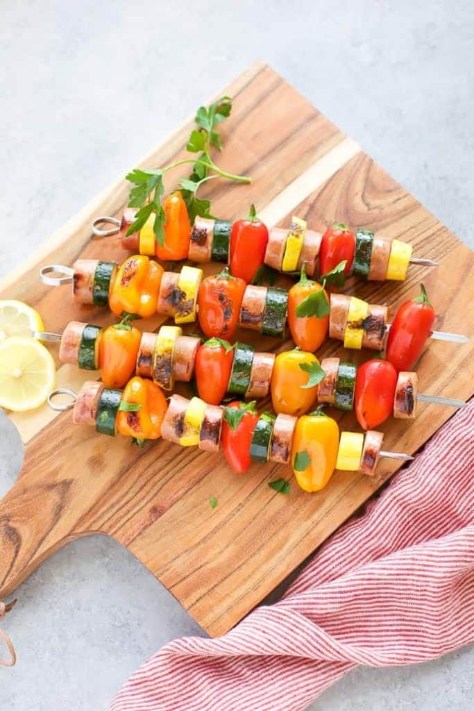 Chicken Sausage Skewers with Vegetables on skewers on a cutting board