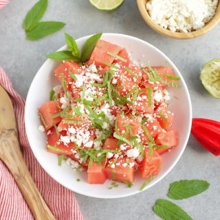 skinny watermelon feta salad in white bowl with mint