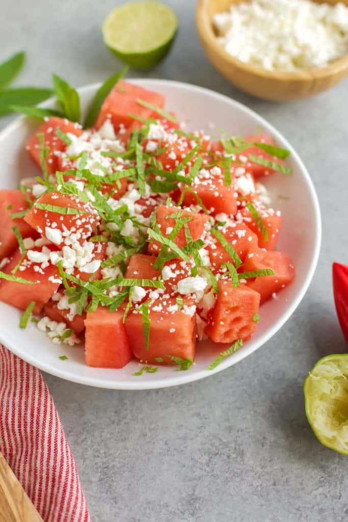 Skinny watermelon feta salad in a white bowl with mint