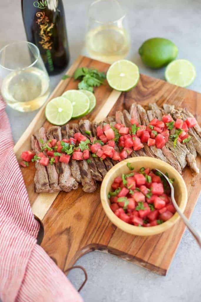 Grilled Skirt Steak with Watermelon Salsa on a cutting board