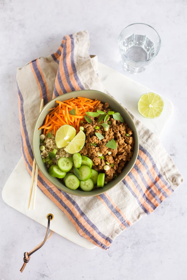 An Asian beef and quinoa bowl with carrots and cucumbers.