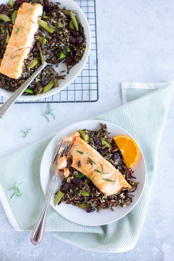 baked salmon with black rice on a white plate