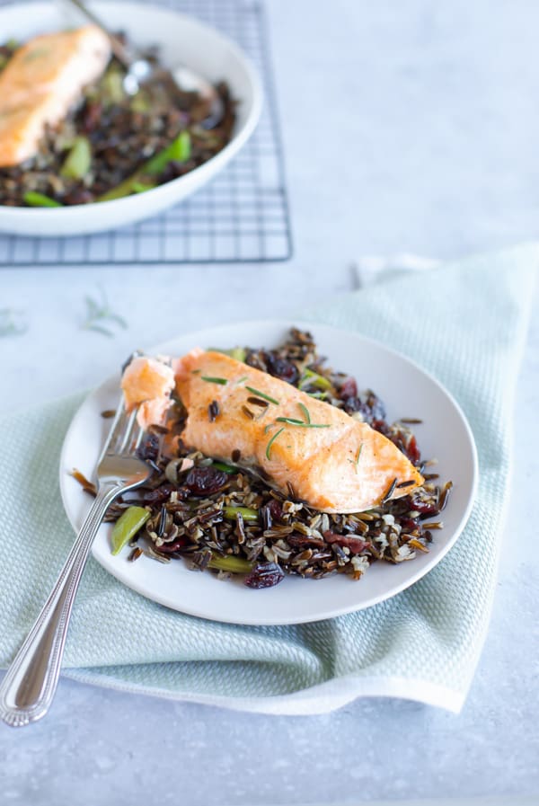 baked salmon with black rice close up with fork