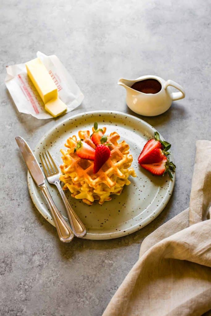 gluten free almond flour waffles with butter and syrup on the side