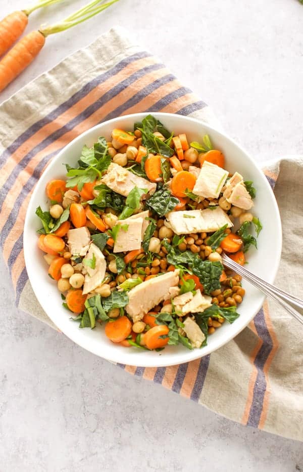 A bowl of lentil salad with chickpeas.