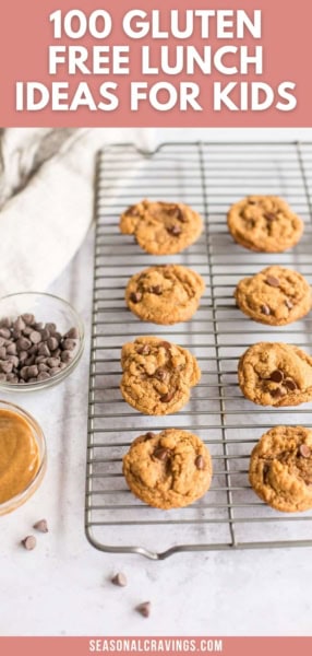 A cooling rack holds seven chocolate chip cookies. A bowl of chocolate chips and a dish of peanut butter are placed beside the rack. The text above reads, "100 Gluten Free Lunchbox Ideas for Kids".