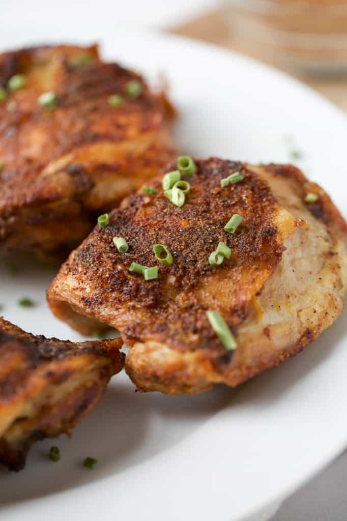 air fryer chicken thighs on a white plate