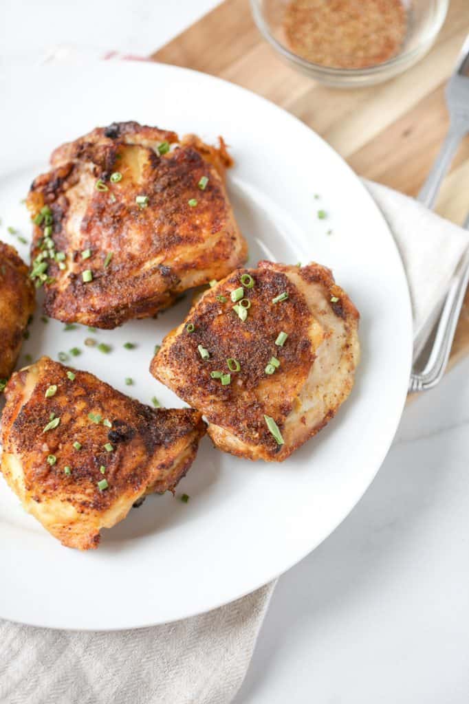  chicken thighs on a white plate