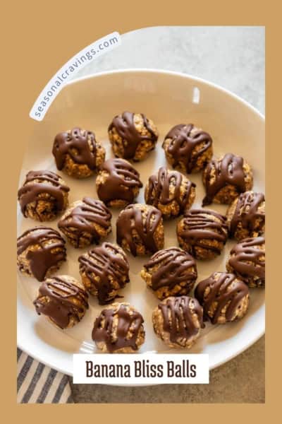 A white bowl contains several round, chocolate-drizzled banana bliss balls. Text on the image reads "seasonalcravinging.com" and "Banana Bliss Balls.