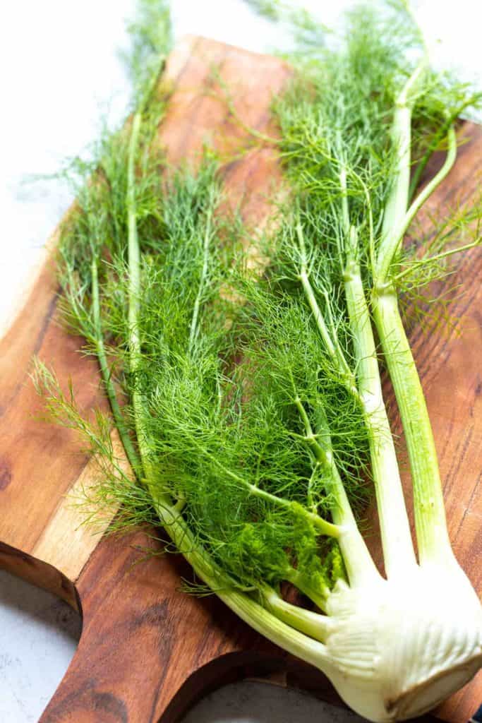 large fennel bulb on a brown butcherblock board 