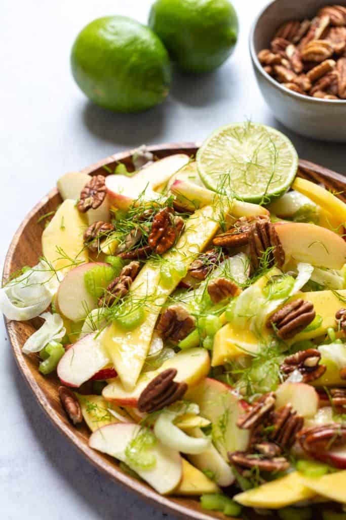 close up of fennel mango and apple salad with dressing 