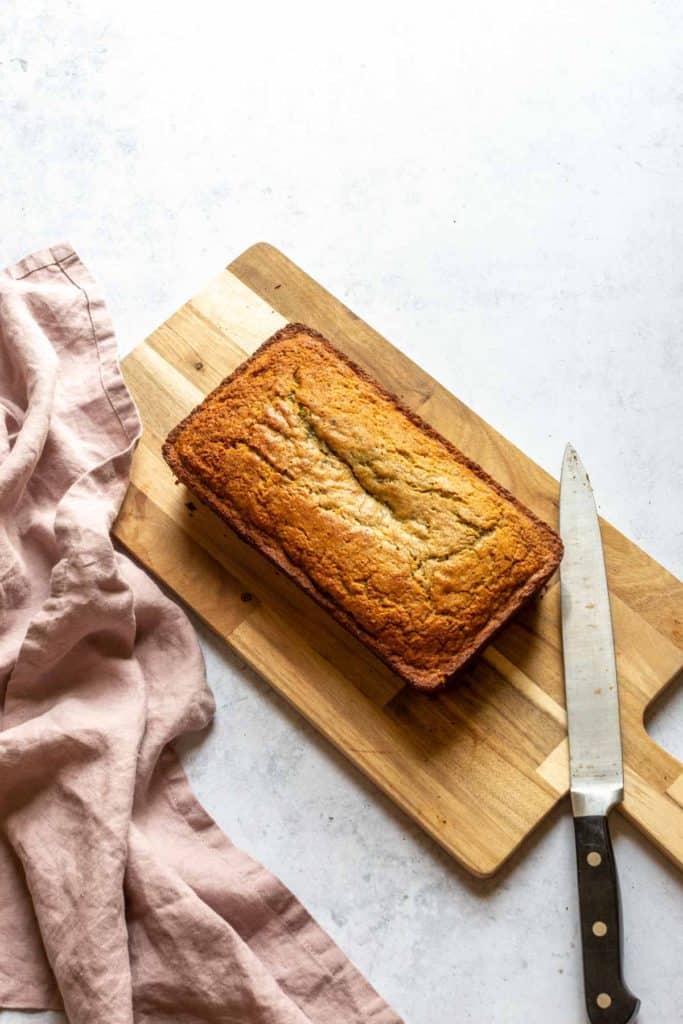 blackberry banana bread on a cutting board with a knife