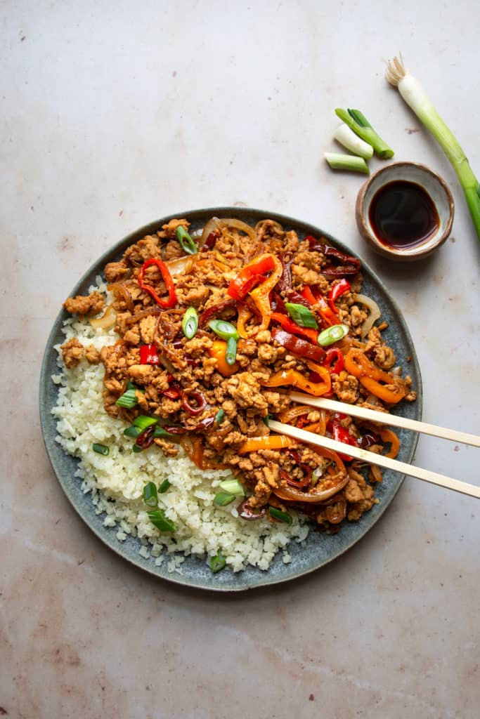 kung pao chicken with chopsticks on a plate