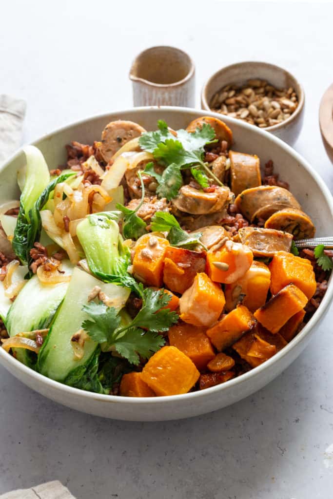 grain bowl with rice, sausage, butternut squash and bok choy