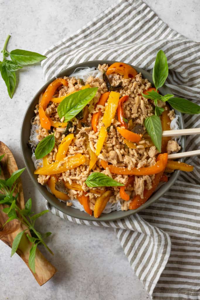 thai basil chicken on a plate with garnish