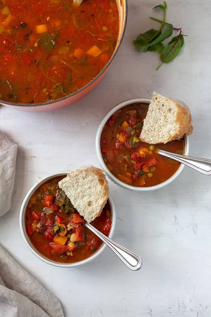 panera bread 10 vegetable soup with poblano peppers in two bowls