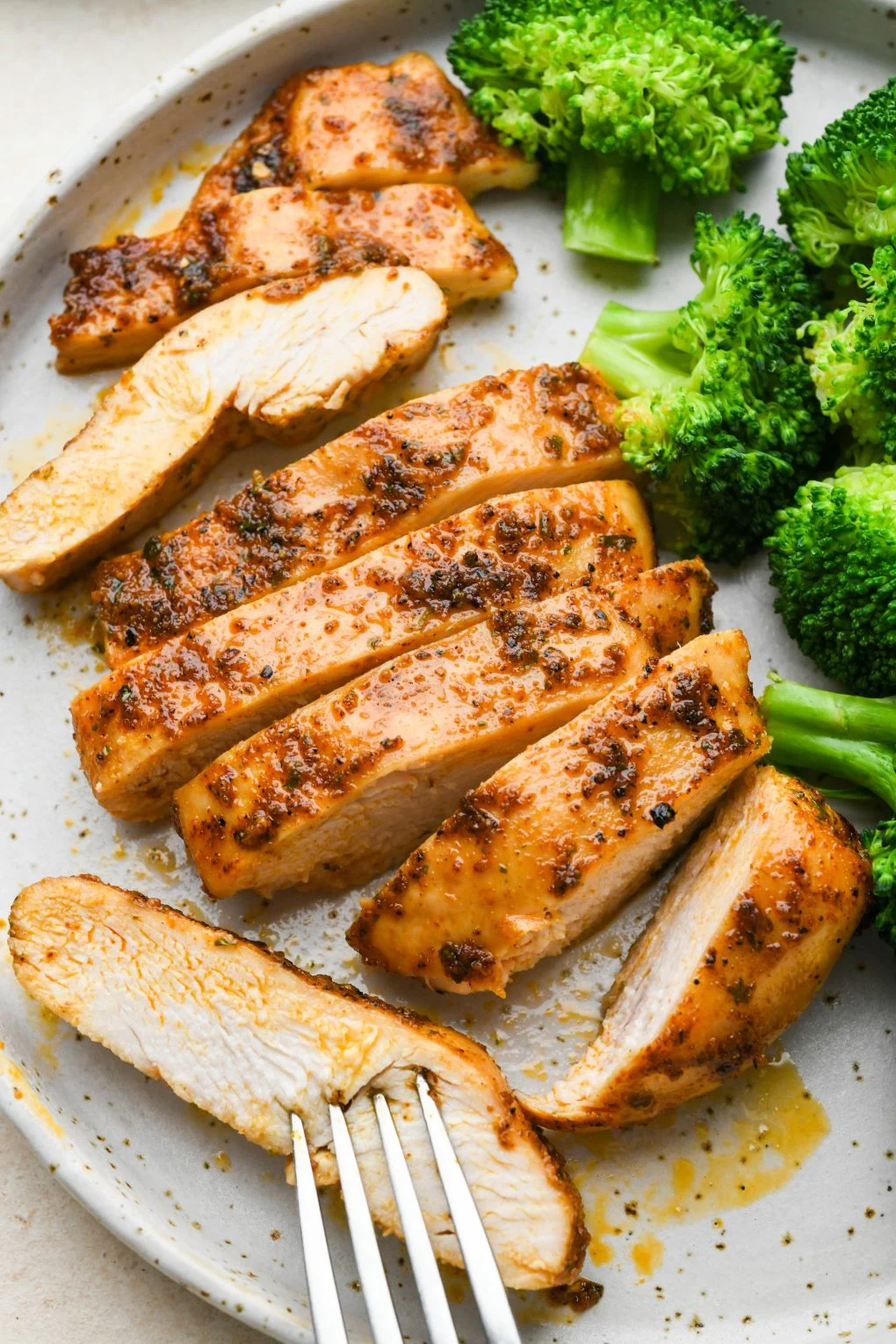 Chicken and broccoli on a plate.