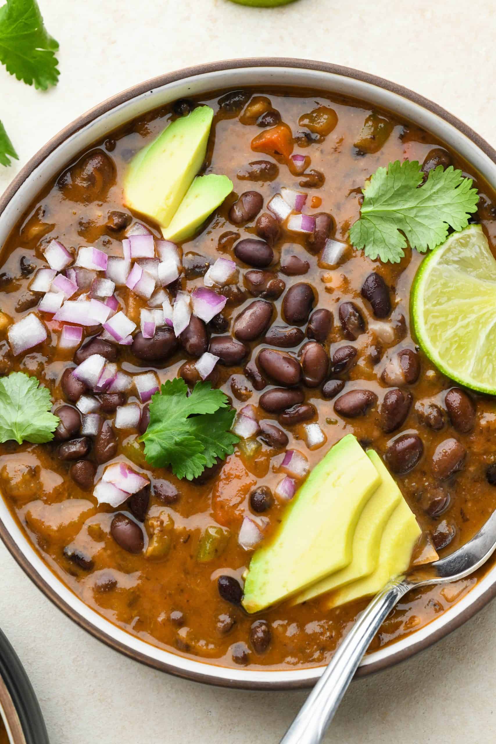 A gluten-free bowl of black bean and avocado soup.