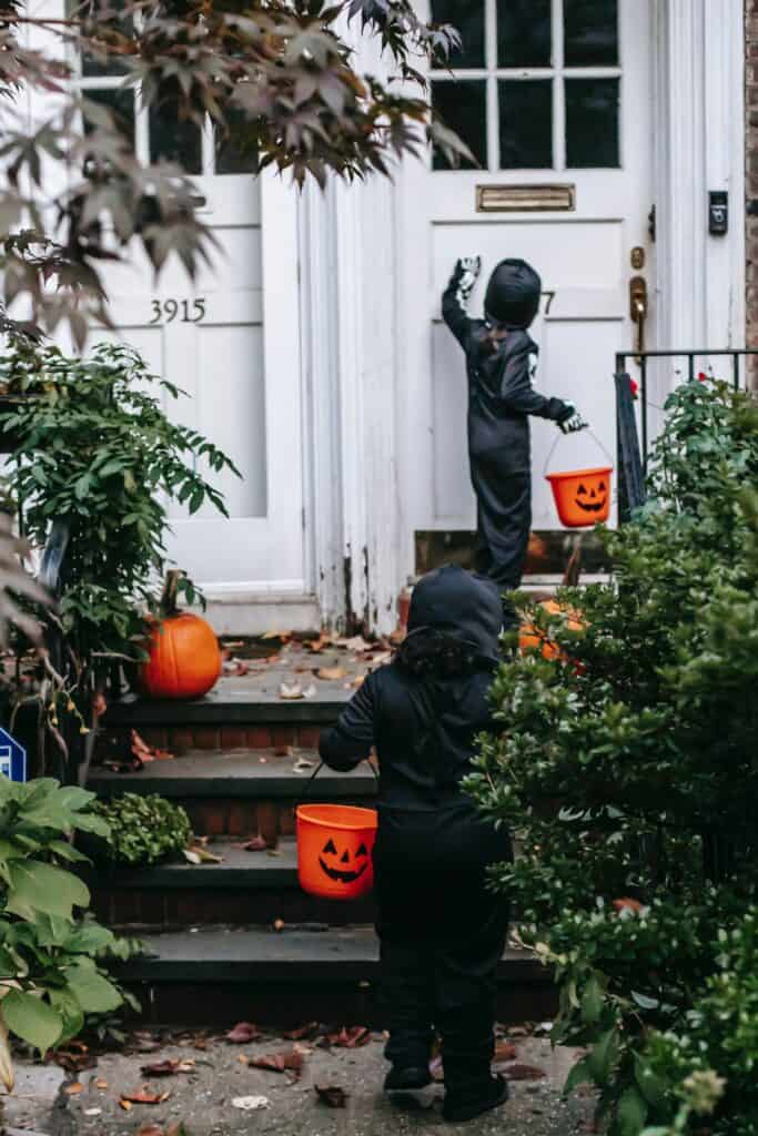 trick or treaters knocking on a front door