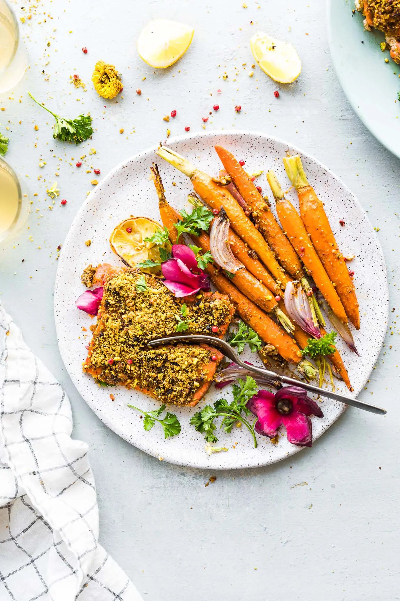 A gluten-free plate with carrots and pistachios.