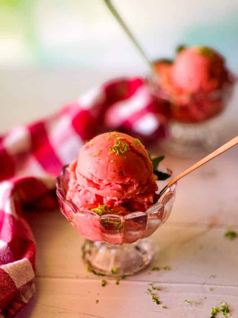 Two bowls of strawberry ice cream on a table.