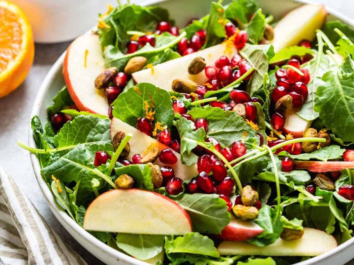 kale salad close up with apple slices on top