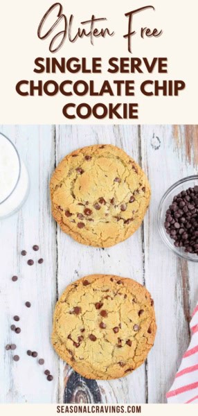 Two gluten-free chocolate chip cookies are placed on a white wooden surface, accompanied by a glass of milk and a small bowl of chocolate chips. The text reads: "Gluten Free Single Serve Chocolate Chip Cookie Delight".