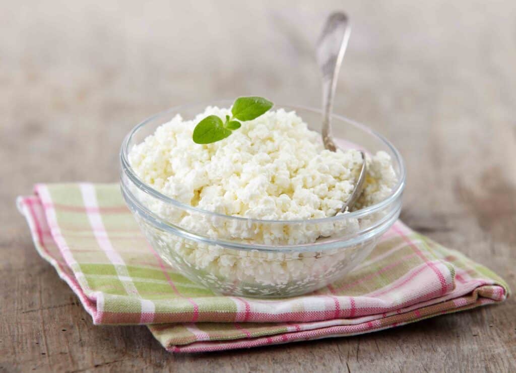 fresh cottage cheese on old wooden table