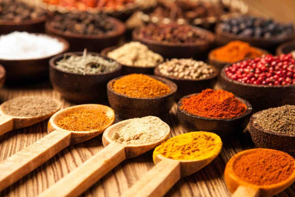 Spices and herbs in wooden bowls. Food and cuisine ingredients.