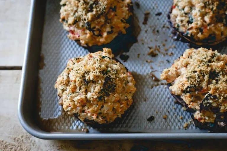 29 Stuffed mushrooms on a baking sheet.