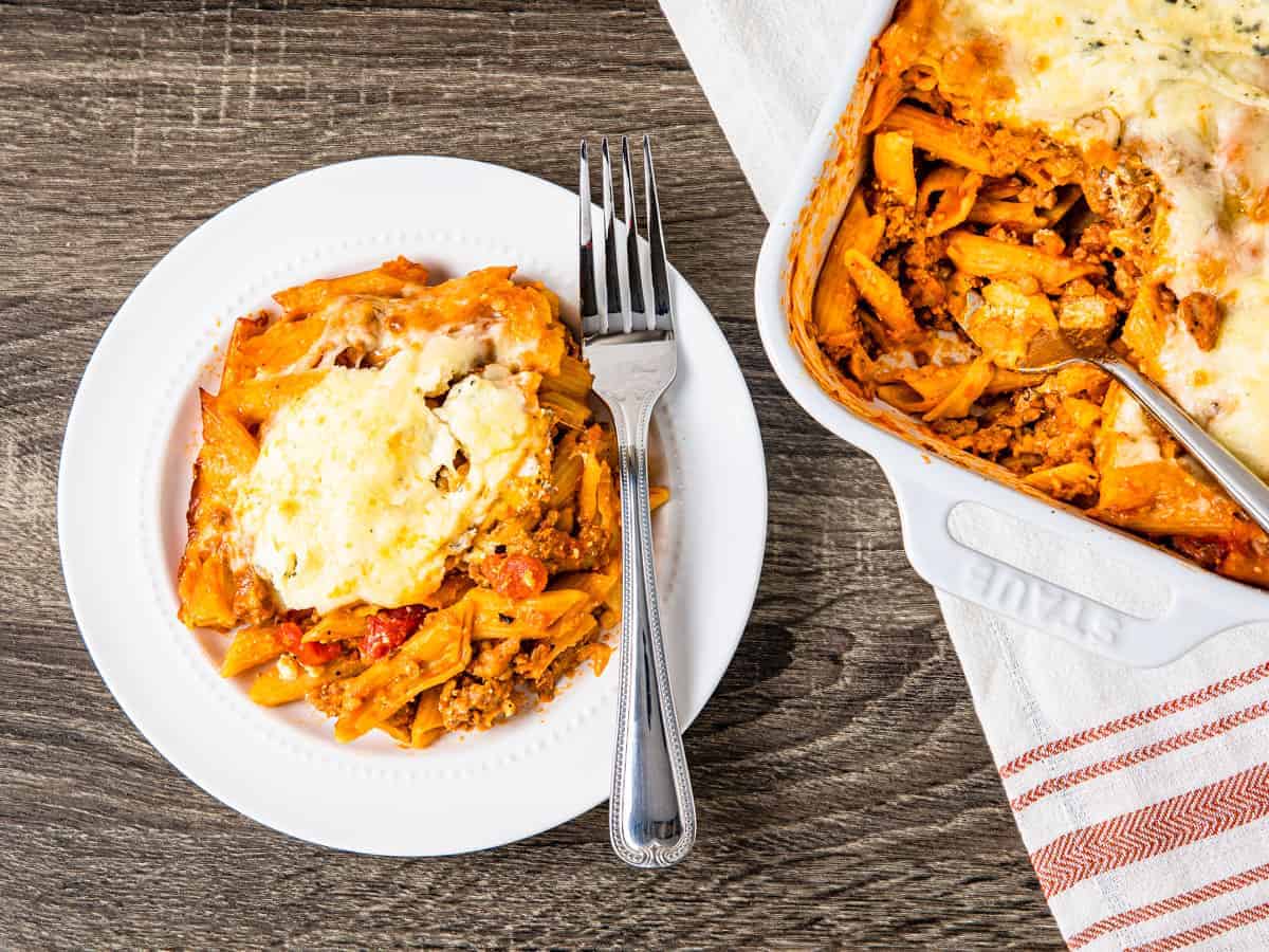 A plate of pasta with ground turkey and cheese.