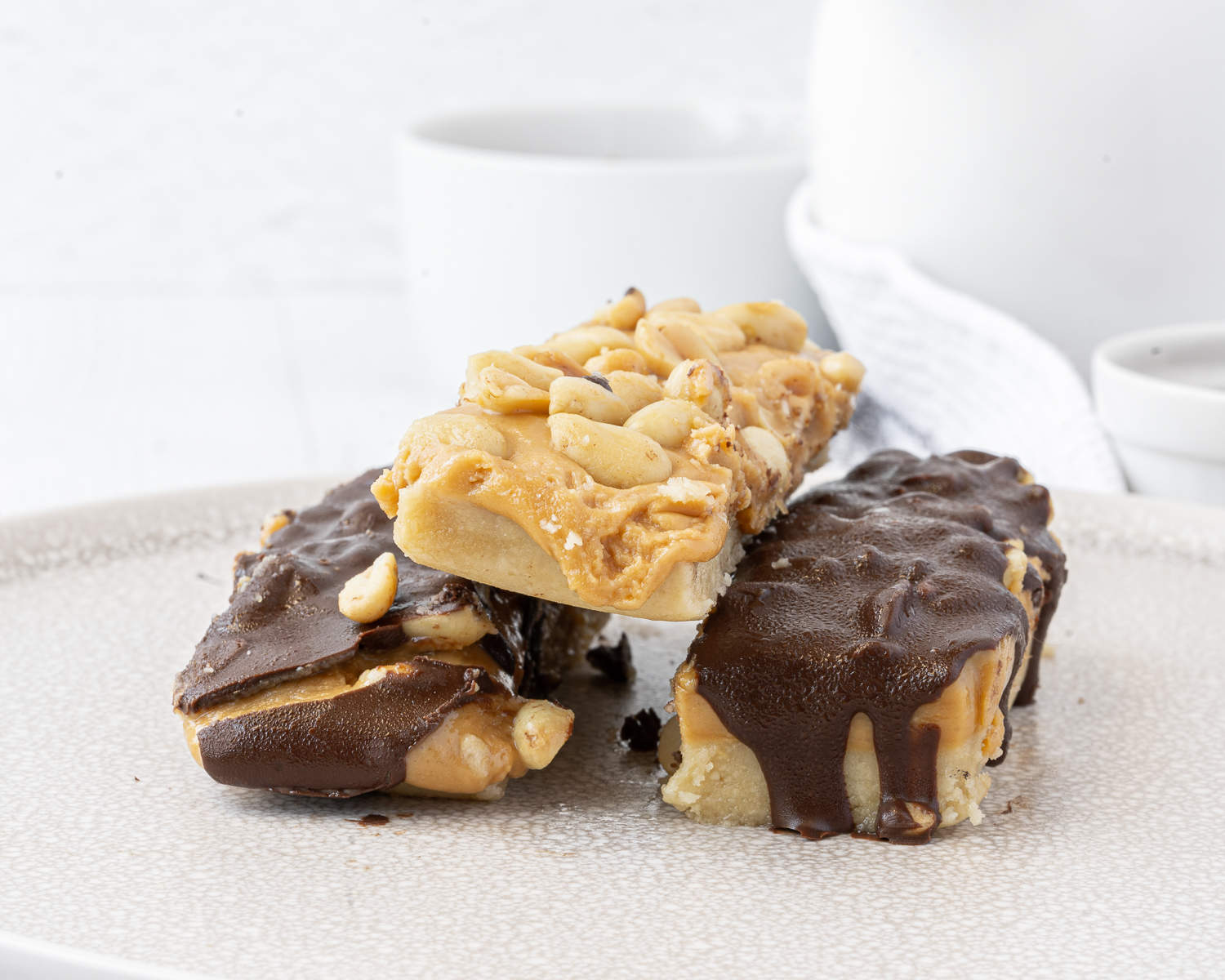 An easy gluten free dessert, featuring a white plate with a peanut butter and chocolate bar on it.